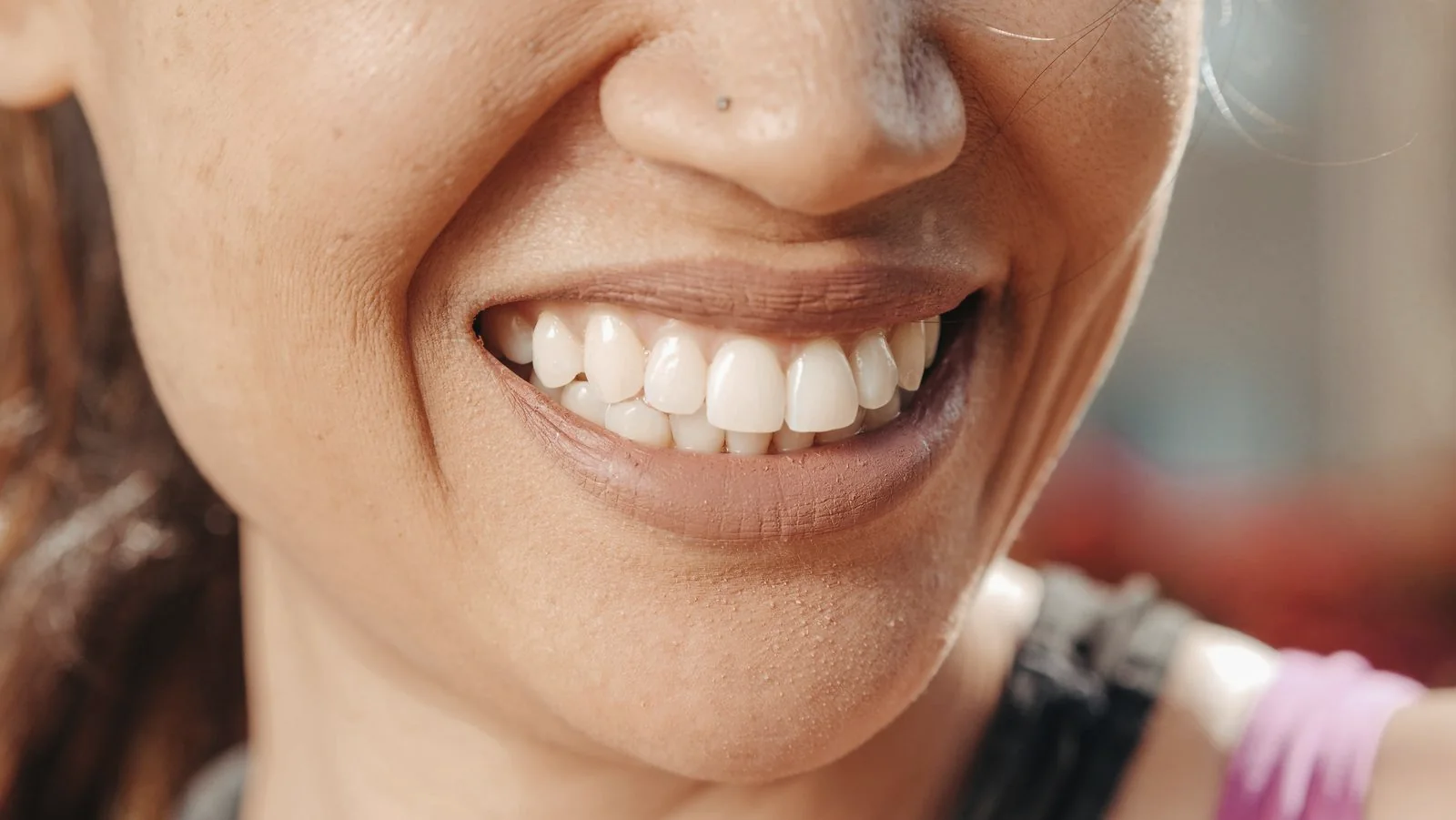 Natural adult smile in soft daylight, shown as editorial lifestyle photography